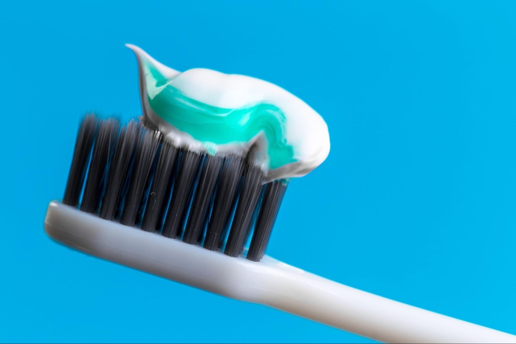 Toothpaste on the end of a toothbrush. 