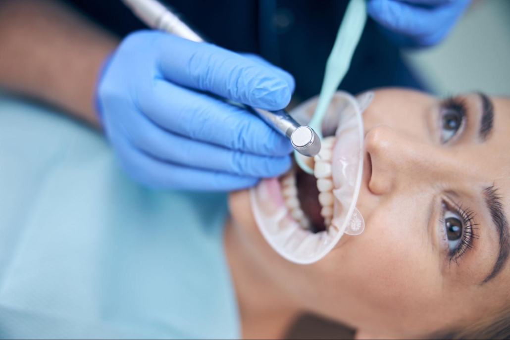 A woman is undergoing a dental procedure.